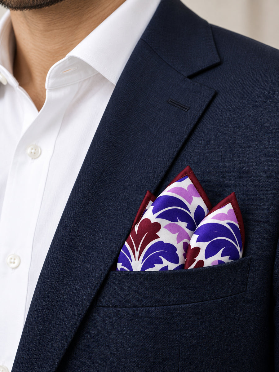 Antique Abstract pocket square with purple, lavender and burgundy acanthus print on white — navy jacket · pointed fold.