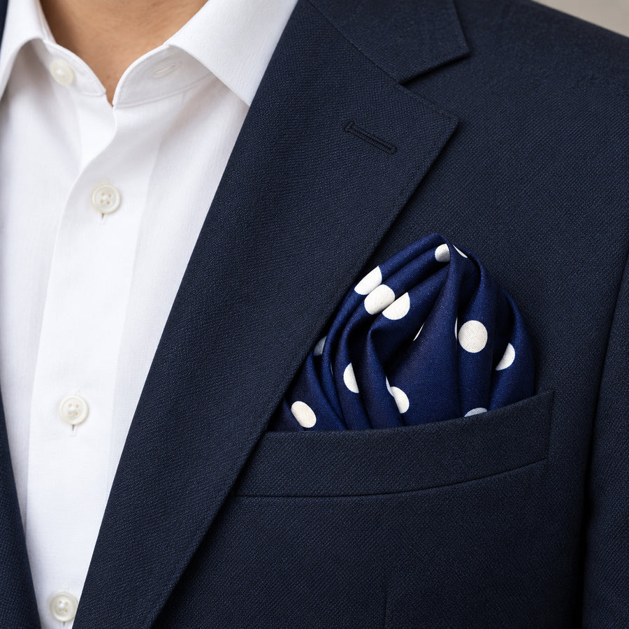 Blue Polka Drops pocket square — navy jacket · alternate fold.