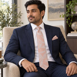 Blush Laurel Leaf silk tie and matching pocket square — Navy suit · seated lifestyle