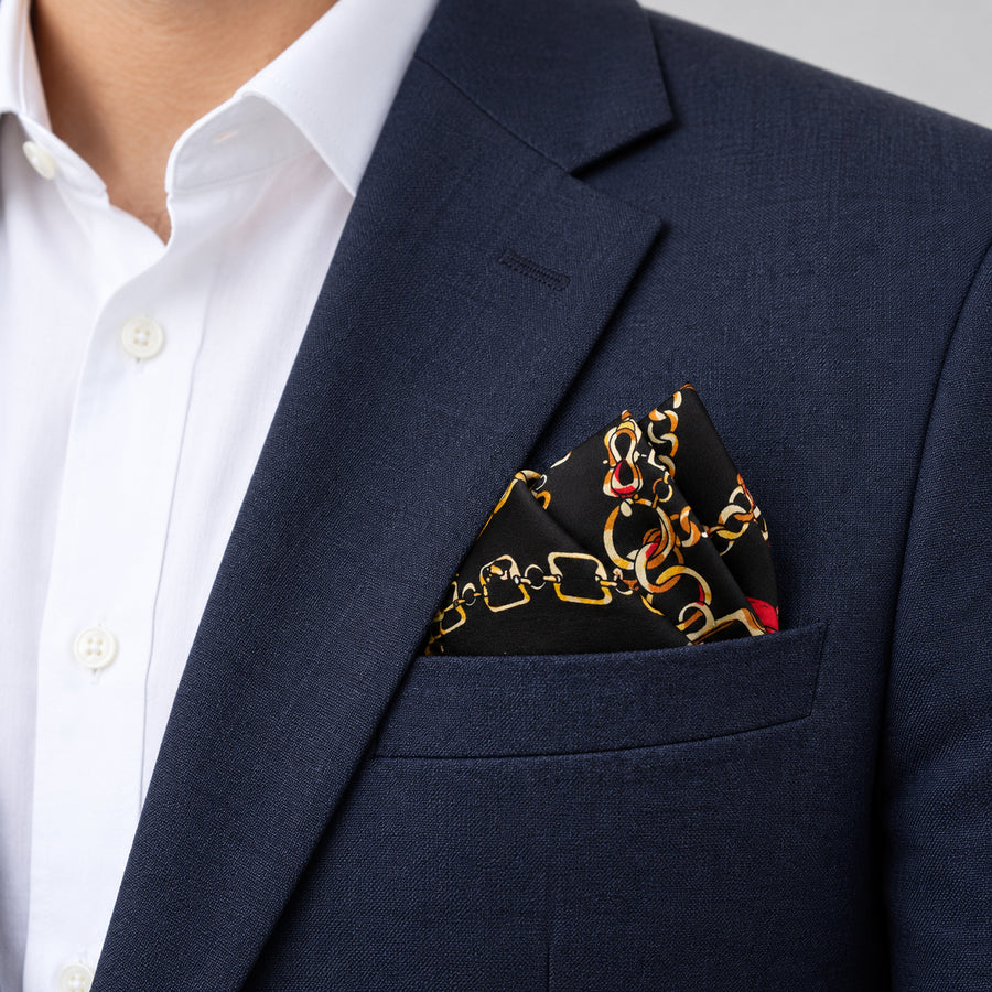 Chains and Straps (Black) pocket square — navy jacket · alternate fold.