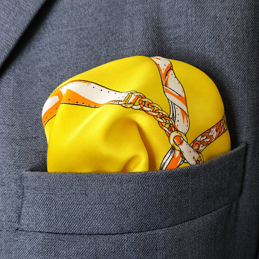 Chains and Straps (yellow) pocket square — close-up wearing detail.