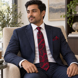 Crimson Leaf Silhouette silk tie and matching pocket square — Navy suit · seated lifestyle