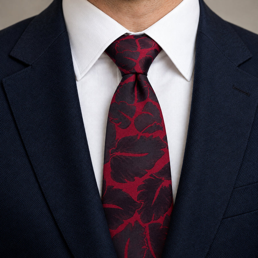 Crimson Leaf Silhouette Silk Tie — Knot and lapel close-up