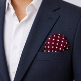 Dark Maroon with White Polka Dots pocket square — navy jacket · wearing detail.