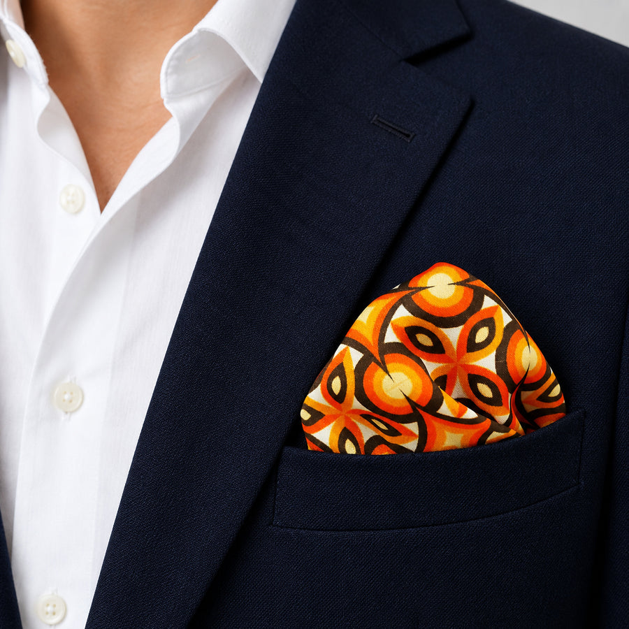 Geometric Repeat Pattern pocket square — navy jacket · wearing detail.