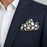 Infinite Geometric Loop pocket square — navy jacket · alternate fold.