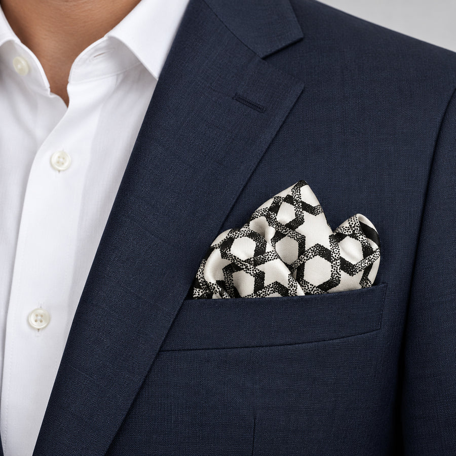 Infinite Geometric Loop pocket square — navy jacket · alternate fold.
