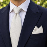 Ivory Scroll Damask silk tie and matching pocket square — Navy peak lapel · pointed fold