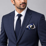Pakistani Markhor pocket square — formal model · navy and tie.