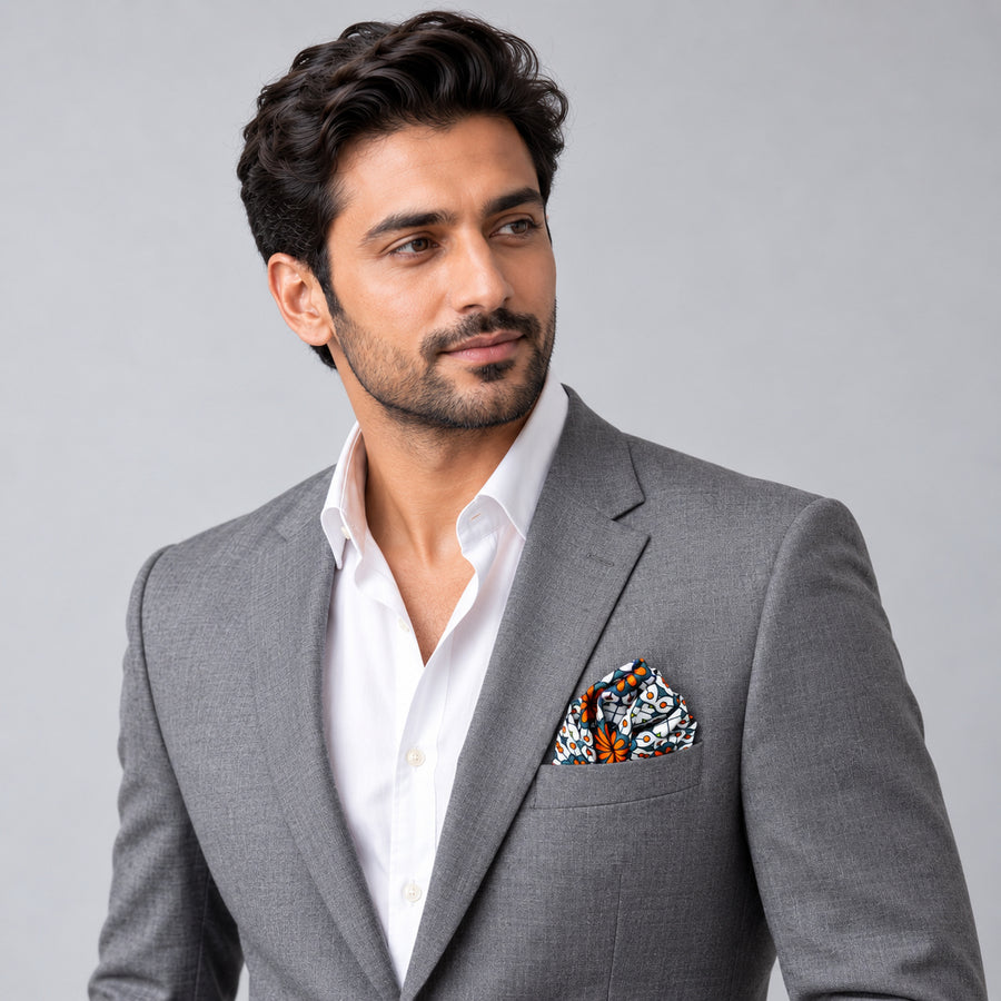 Mexican Floral Loop pocket square — model · light grey and open collar.
