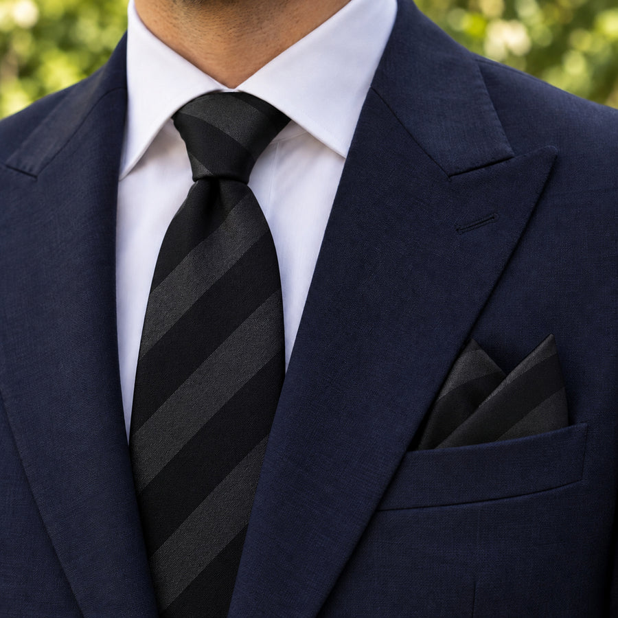 Noir Shadow Stripe silk tie and matching pocket square — Navy peak lapel · pointed fold