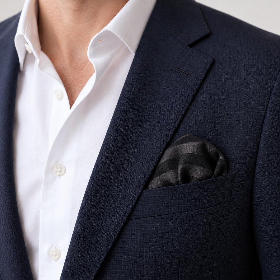 Noir Shadow Striped Silk Pocket Square — Navy jacket · rounded puff
