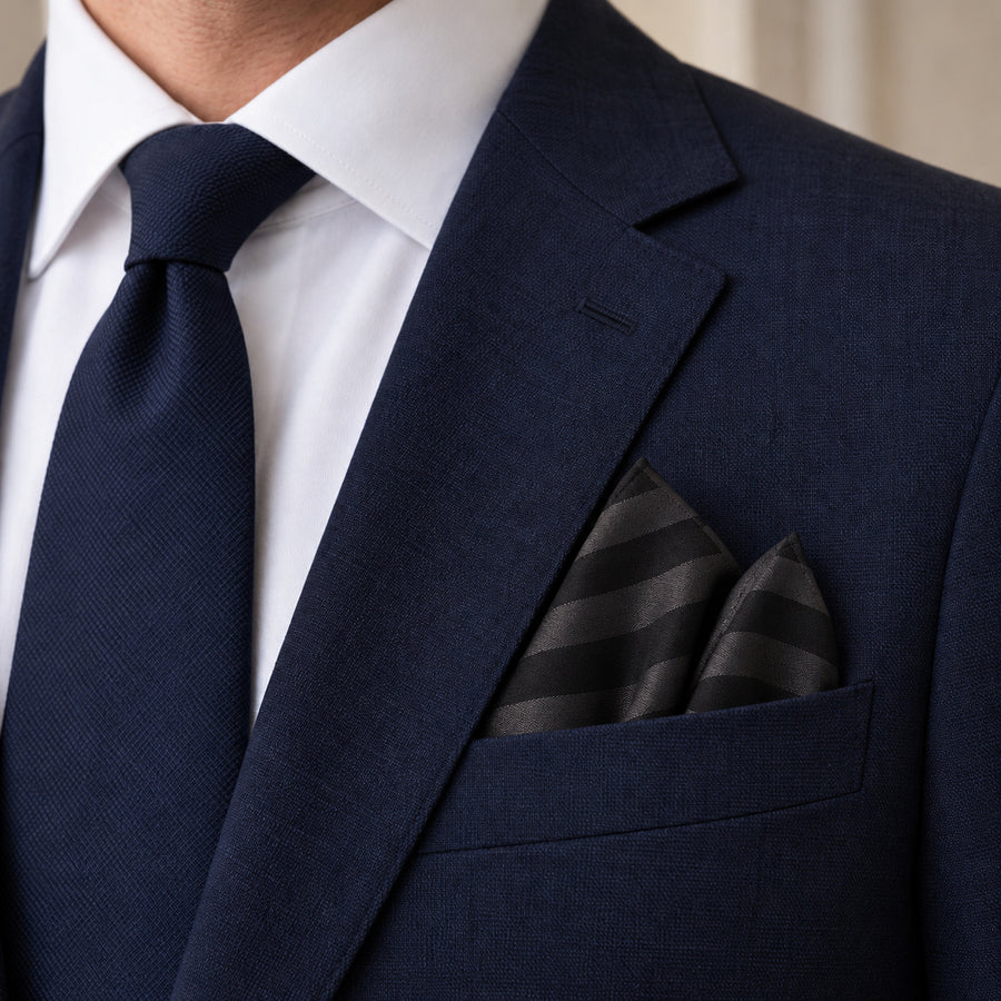 Noir Shadow Striped Silk Pocket Square — Navy jacket · pointed fold