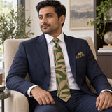 Olive Laurel Leaf silk tie and matching pocket square — Navy suit · seated lifestyle