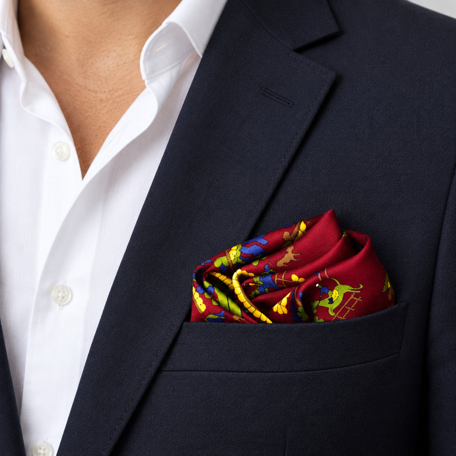 Maroon Paisley and Floral pocket square — navy jacket · wearing detail.