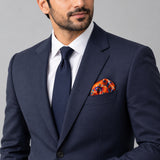 Rust Paisley and Floral pocket square — formal model · navy and tie.