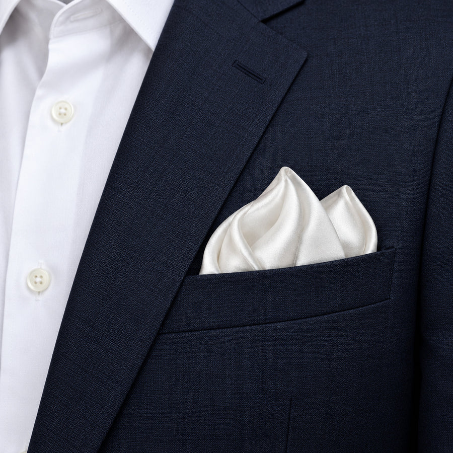 Pearl White Paradigm pocket square — navy jacket · alternate fold.