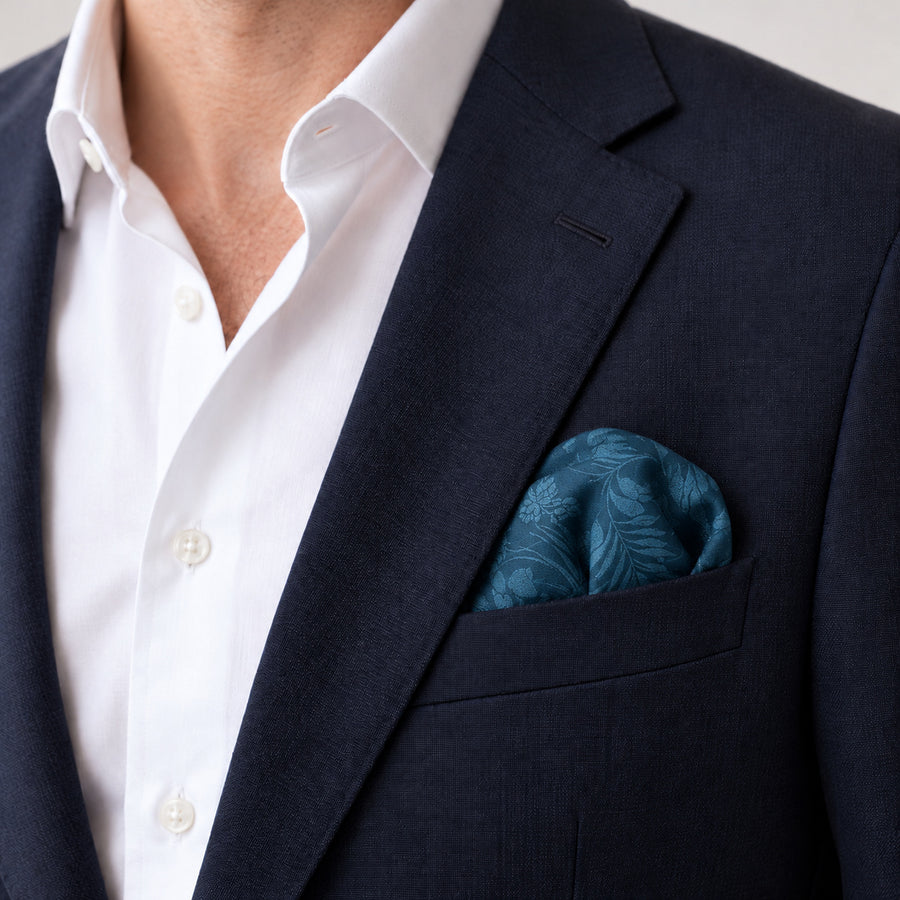Petrol Blue Botanical Jacquard Silk Pocket Square — Navy jacket · rounded puff