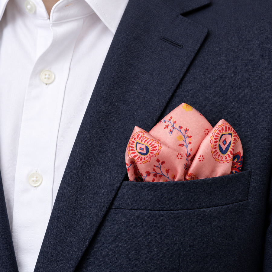 Pink Paisley Petals pocket square — navy jacket · alternate fold.
