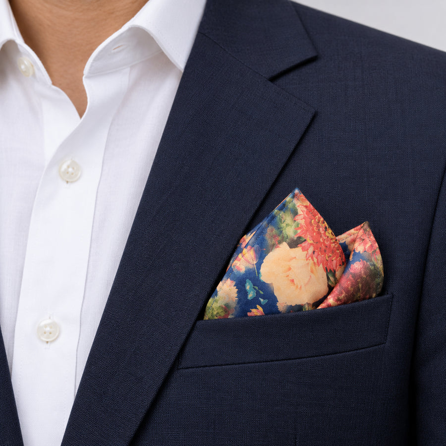 Sapphire Bouquet pocket square — navy jacket · alternate fold.