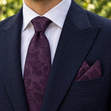 Plum Tropical Bloom silk tie and matching pocket square — Navy peak lapel · pointed fold