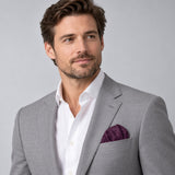 Plum Tropical Bloom Silk Pocket Square — model · light grey and open collar.