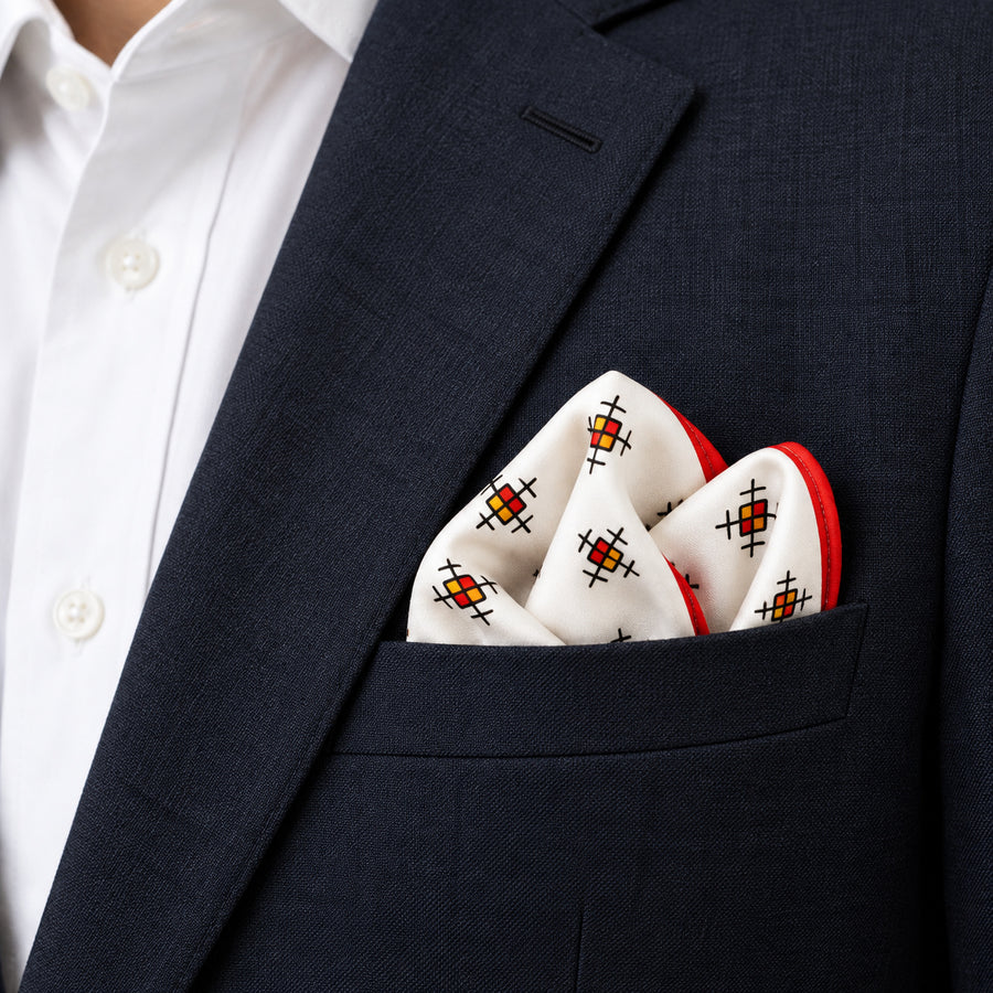 Red Potion pocket square — navy jacket · alternate fold.