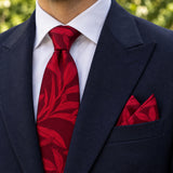 Scarlet Laurel Leaf silk tie and matching pocket square — Navy peak lapel · pointed fold