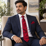 Scarlet Laurel Leaf silk tie and matching pocket square — Navy suit · seated lifestyle
