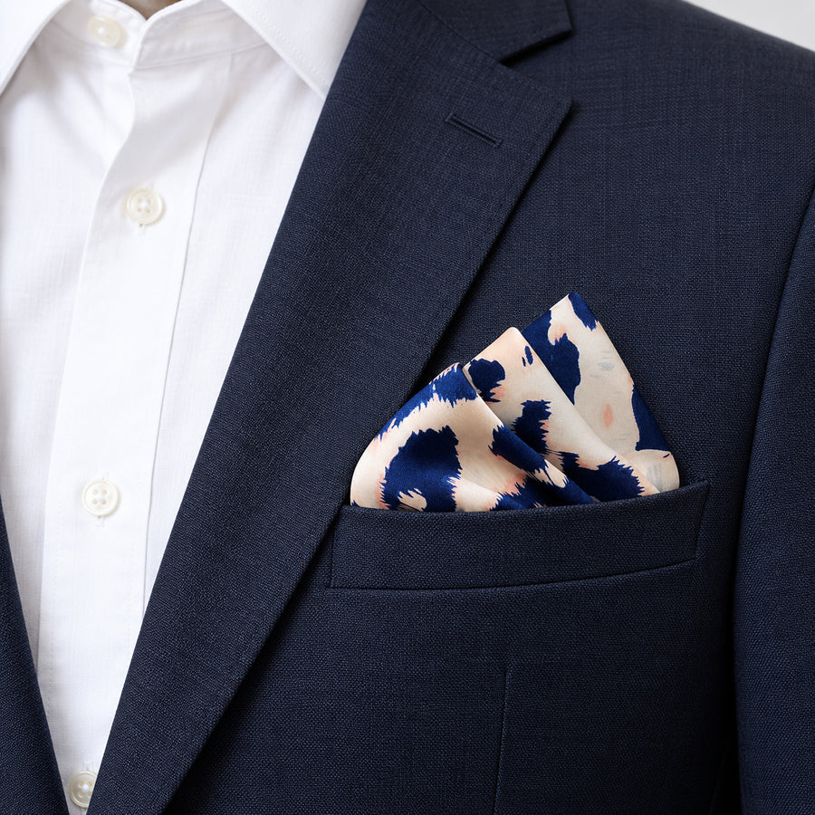 Snow Leopard pocket square — navy jacket · alternate fold.