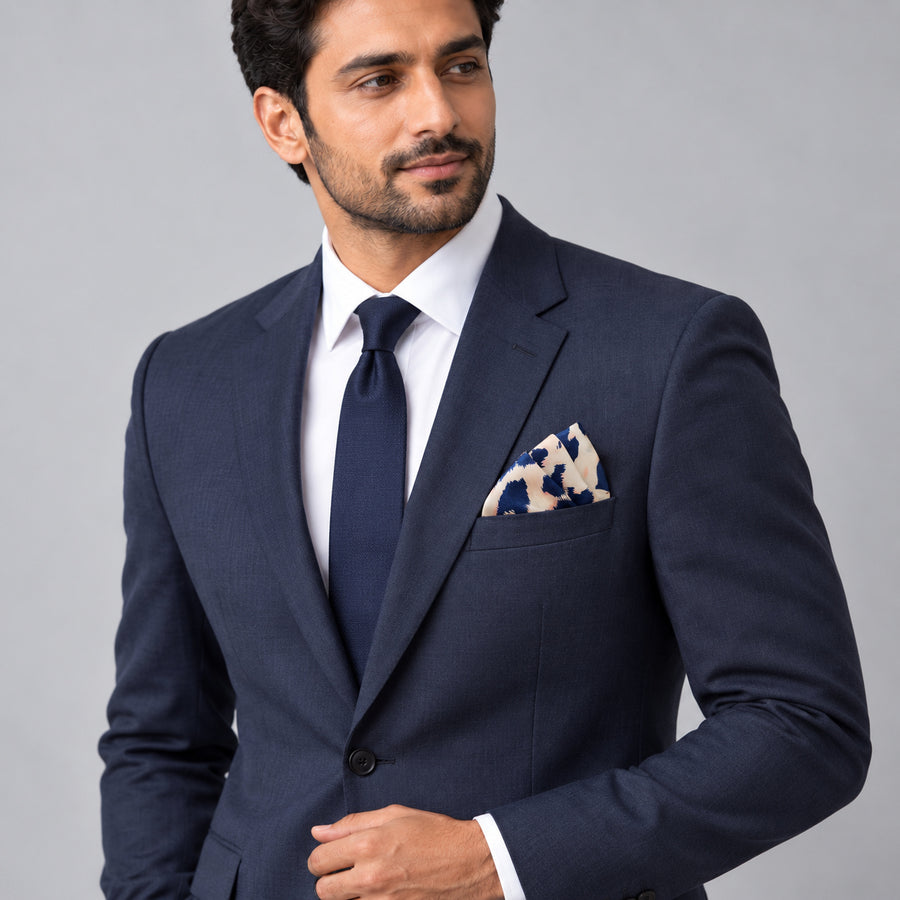 Snow Leopard pocket square — formal model · navy and tie.