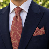 Terracotta Leaf Silhouette silk tie and matching pocket square — Navy peak lapel · pointed fold