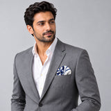 The Blue Chronicles pocket square — model · light grey and open collar.