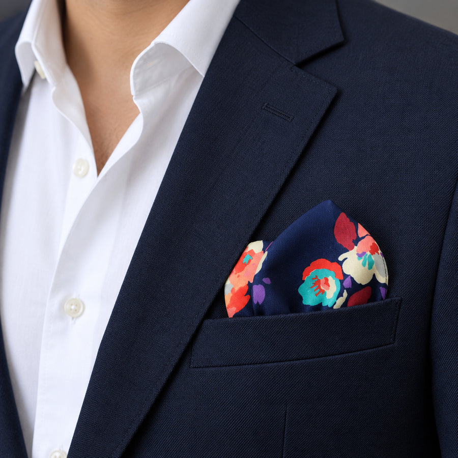 The Deep Blue Floral pocket square — navy jacket · wearing detail.