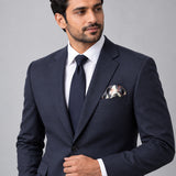 The Grey Garden pocket square — formal model · navy and tie.
