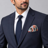 The Paisley Petals pocket square — formal model · navy and tie.