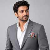 The Paisley Petals pocket square — model · light grey and open collar.