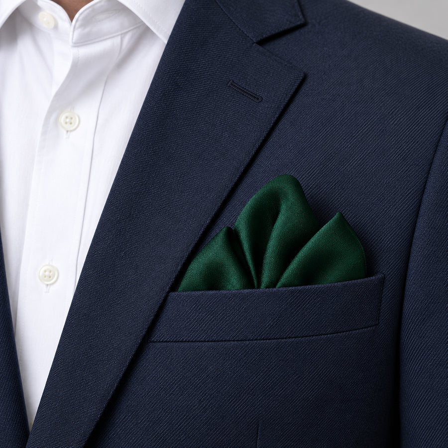 Deep Green pocket square — navy jacket · alternate fold.