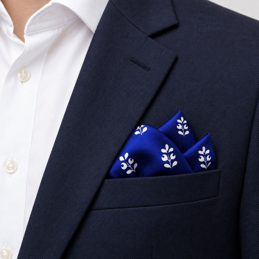 White Conifer pocket square — navy jacket · alternate fold.