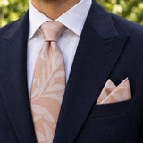 Blush Laurel Leaf silk tie and matching pocket square — Navy peak lapel · pointed fold