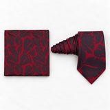 Crimson Leaf Silhouette silk tie and matching pocket square — Natural coiled pair