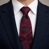 Crimson Leaf Silhouette Silk Tie — Knot and lapel close-up