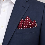 Dark Maroon with White Polka Dots pocket square — navy jacket · alternate fold.