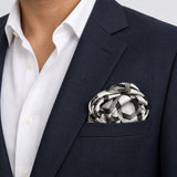 Infinite Geometric Loop pocket square — navy jacket · wearing detail.