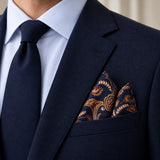 Midnight Copper Paisley Silk Pocket Square — Navy jacket · pointed fold
