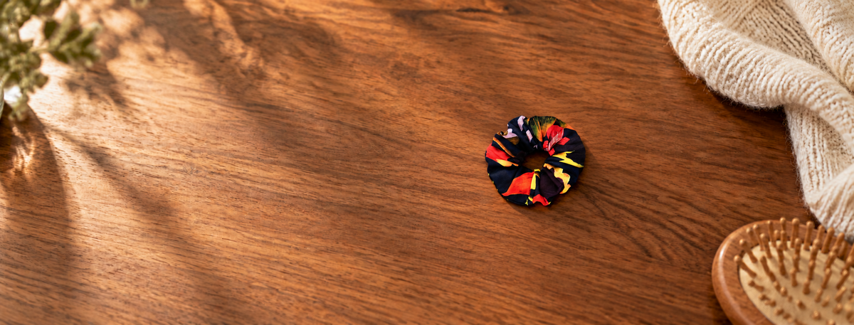 Floral scrunchie resting naturally on a tabletop.