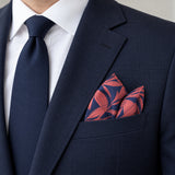 Navy Coral Laurel Leaf Silk Pocket Square — navy jacket · pointed fold.