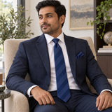 Navy Sateen Stripe silk tie and matching pocket square — Navy suit · seated lifestyle