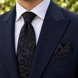 Onyx Damask Scroll silk tie and matching pocket square — Navy peak lapel · pointed fold