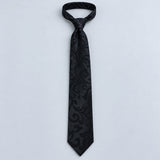 Onyx Damask Scroll Silk Tie — Relaxed knotted layout